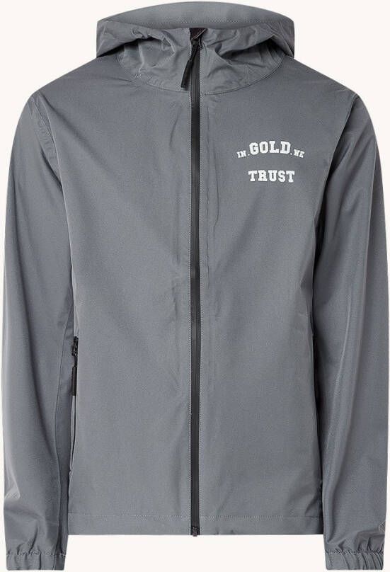In Gold We Trust The Umbrella regenjack met logo en backprint